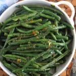 Overhead view of sauteed haricots verts in serving dish
