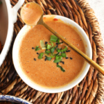 Overhead view of bang bang sauce in bowl with whisk