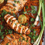 Overhead view of sheet pan chicken fajitas with green onions