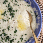 Spoon in bowl of cheesy grits