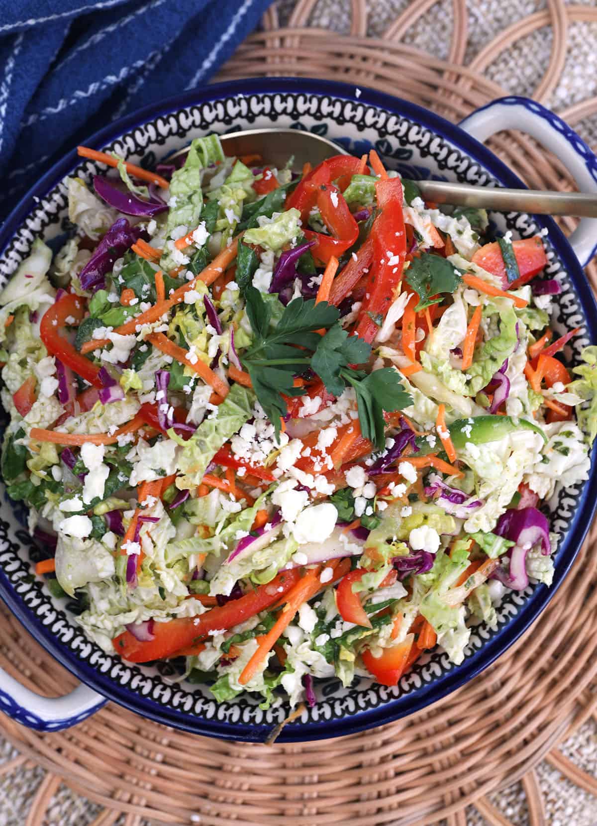 Overhead view of Mexican coleslaw topped with cotija