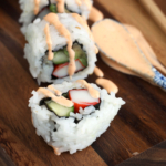 Spicy mayo drizzled over sushi roll