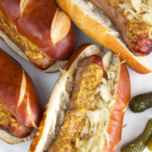 Bratwurst in pretzel rolls with sauerkraut and mustard.