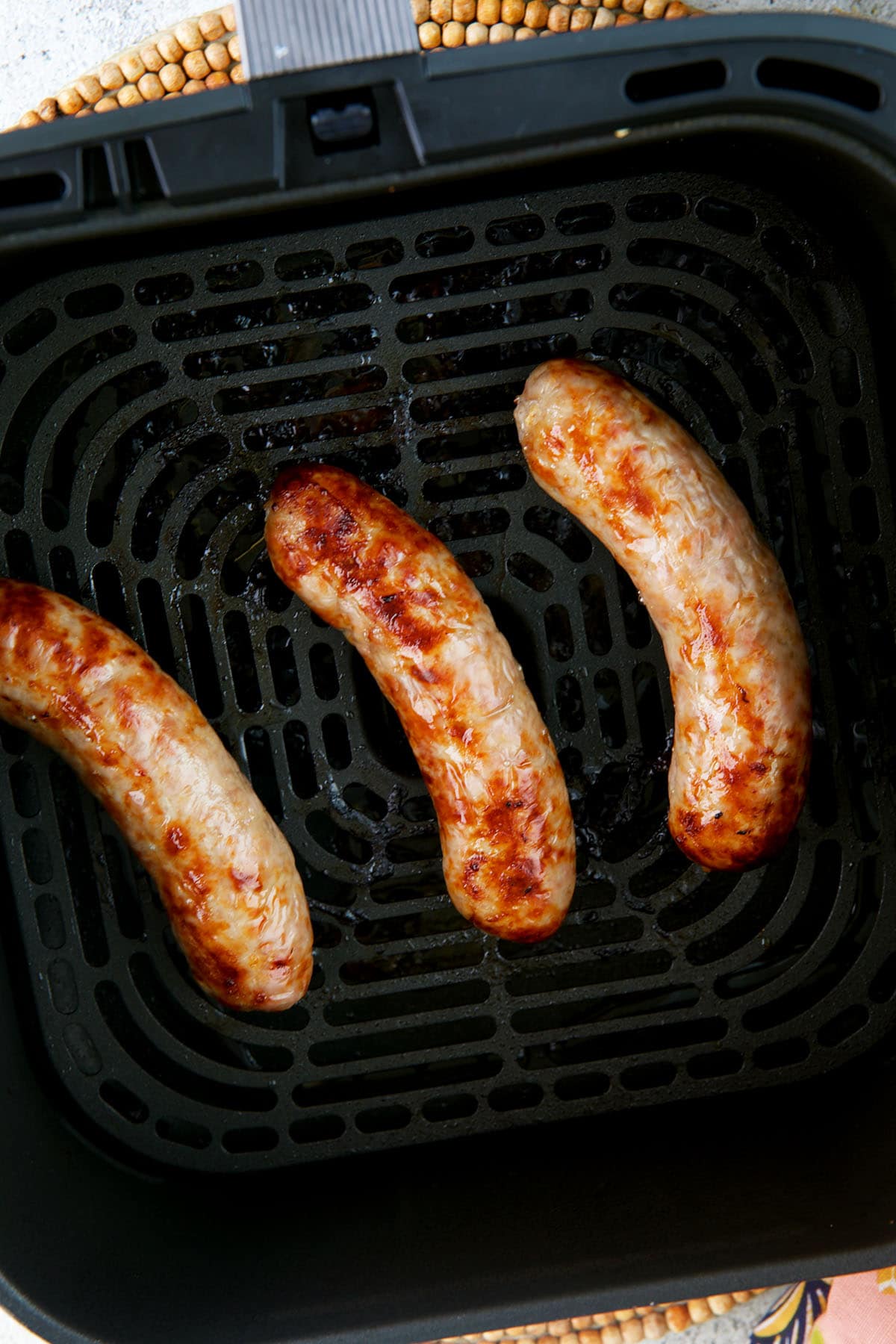 Bratwurst in an air fryer basket