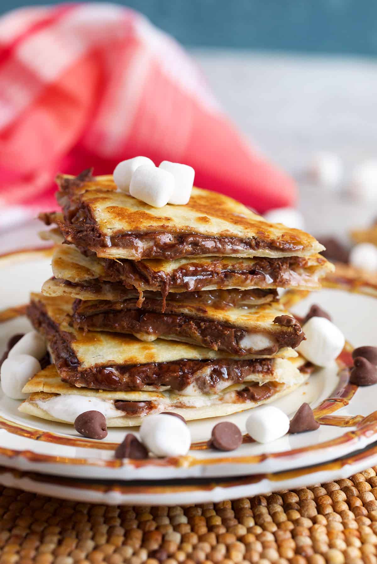 S'mores Quesadilla stacked on a plate and topped with mini marshmallows