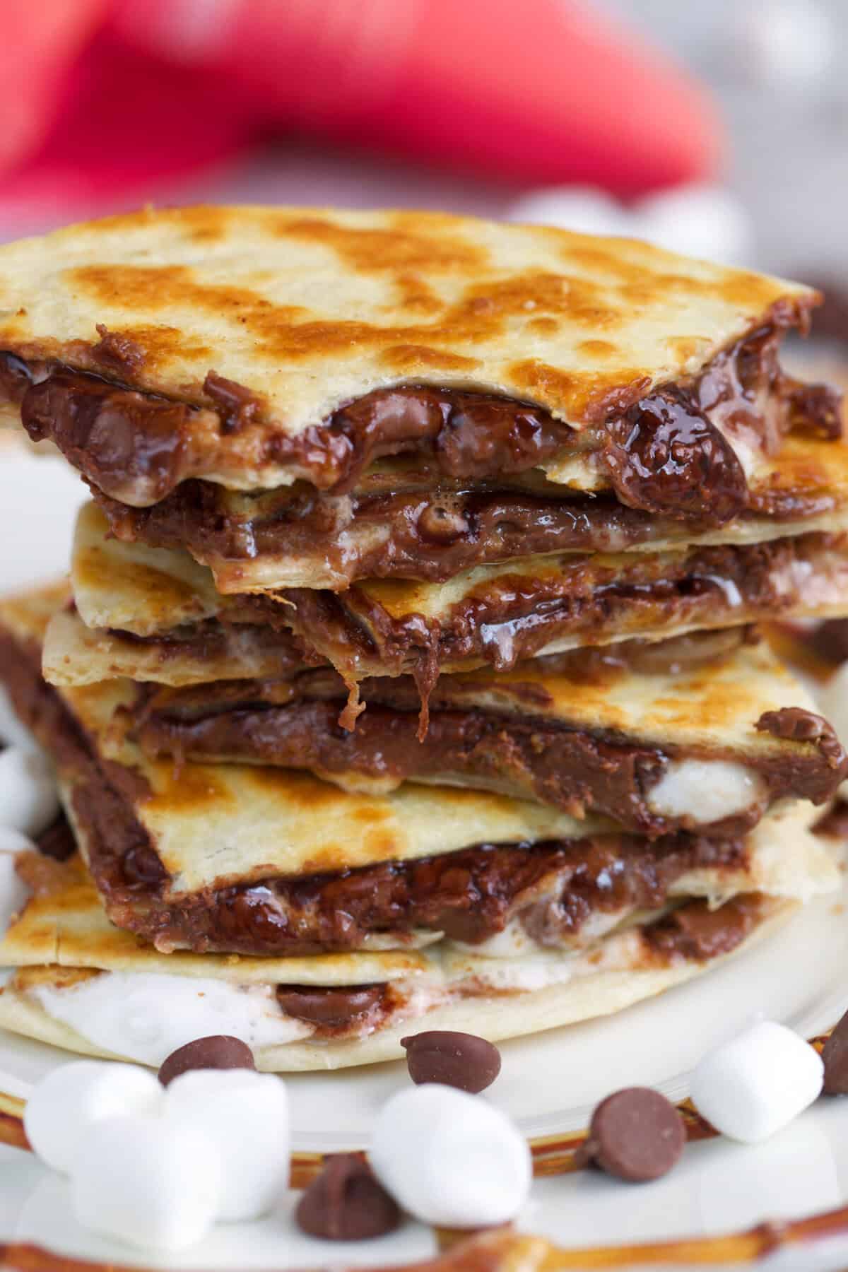 S'mores Quesadillas stacked with a bite out of the top slice.