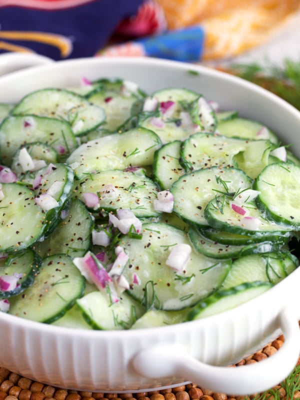 German Cucumber Salad in a white dish with handles.