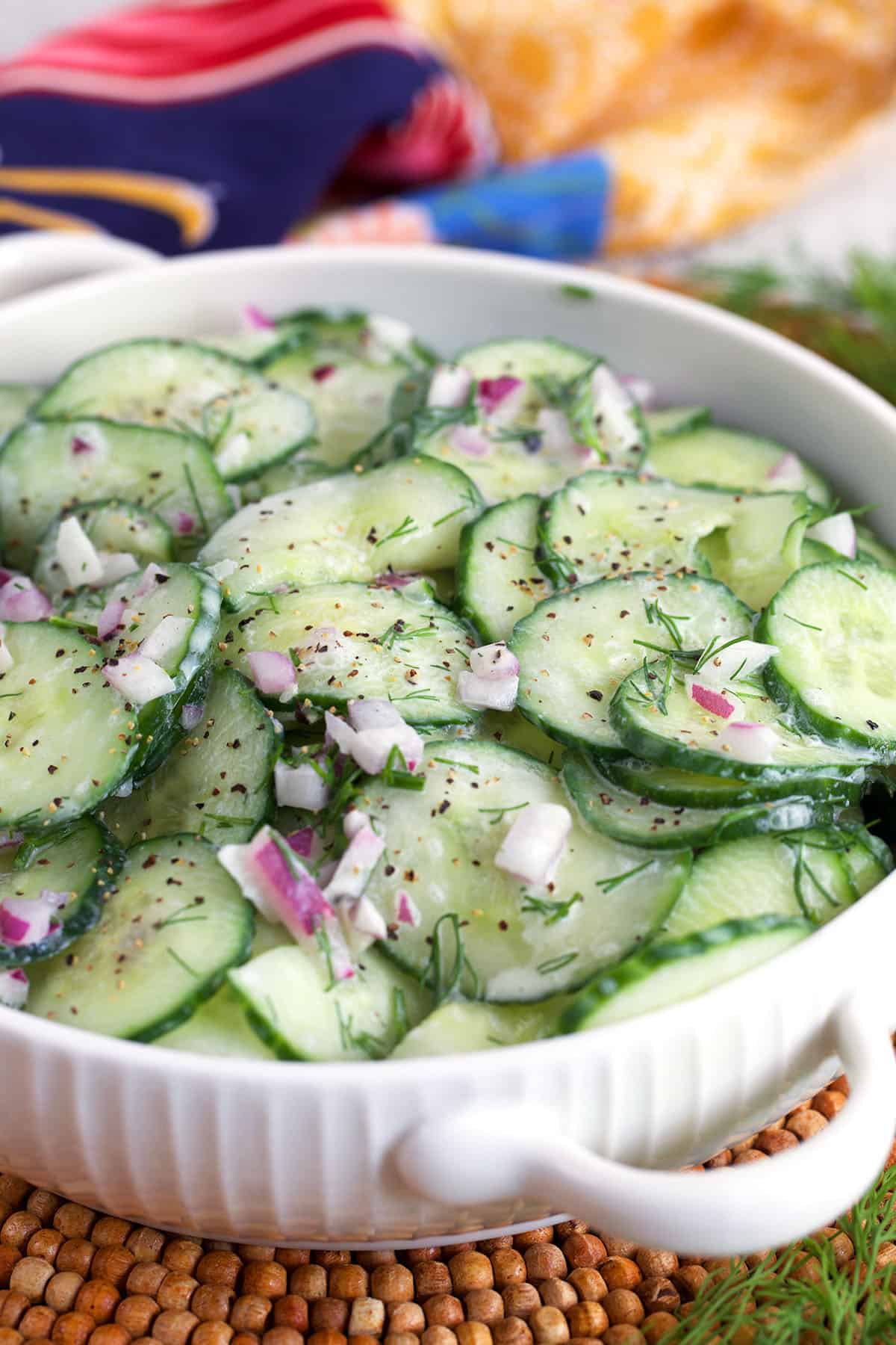 German Cucumber Salad in a white dish with handles.