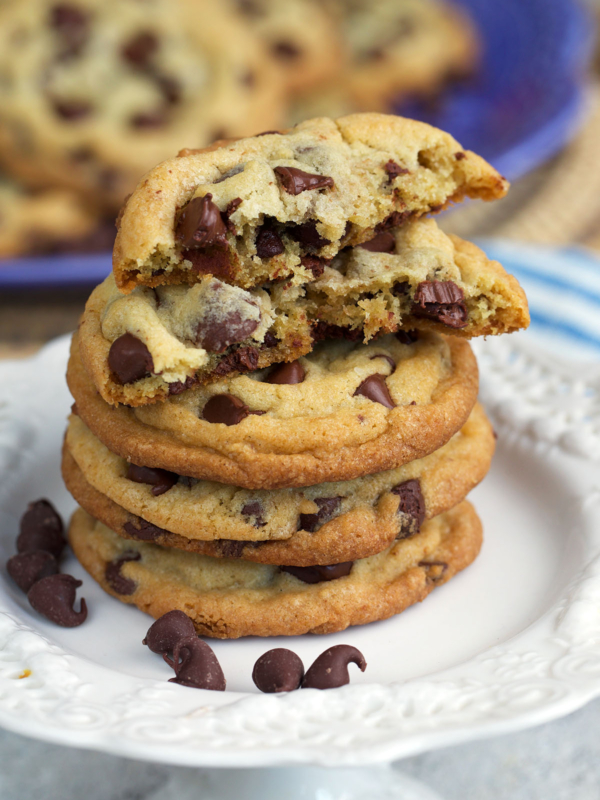 Best chocolate chip cookies stacked on a cupcake stand with a crumb shot.