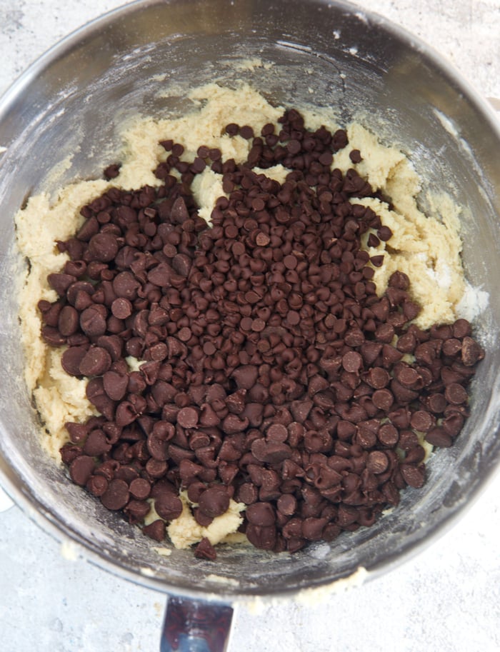 chocolate chips being folded into cookie dough