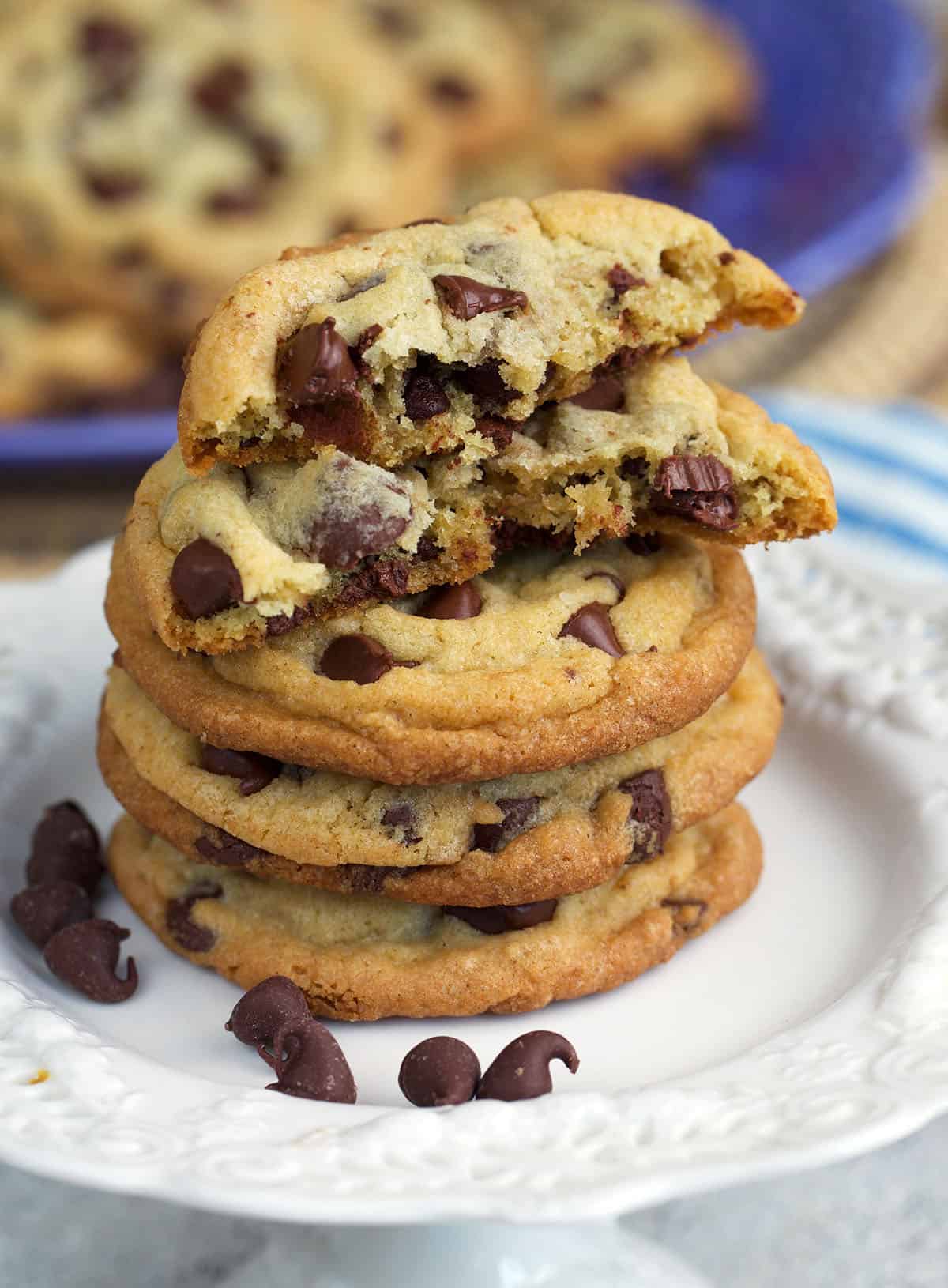 Best chocolate chip cookies stacked on a cupcake stand with a crumb shot.