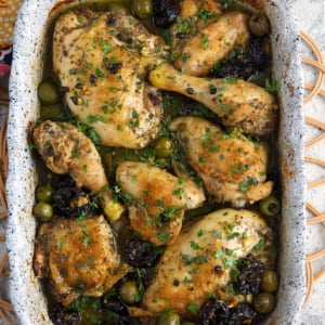 Chicken Marbella in a white baking dish
