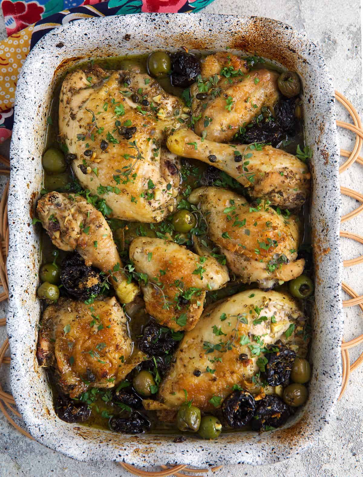 Chicken Marbella in a white baking dish