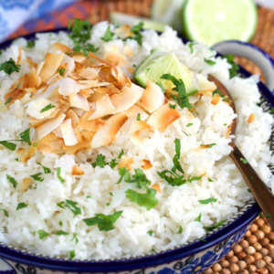 Coconut rice in polish pottery with toasted coconut and cilantro on top