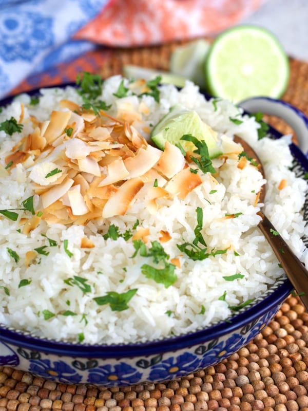 Coconut rice in polish pottery with toasted coconut and cilantro on top
