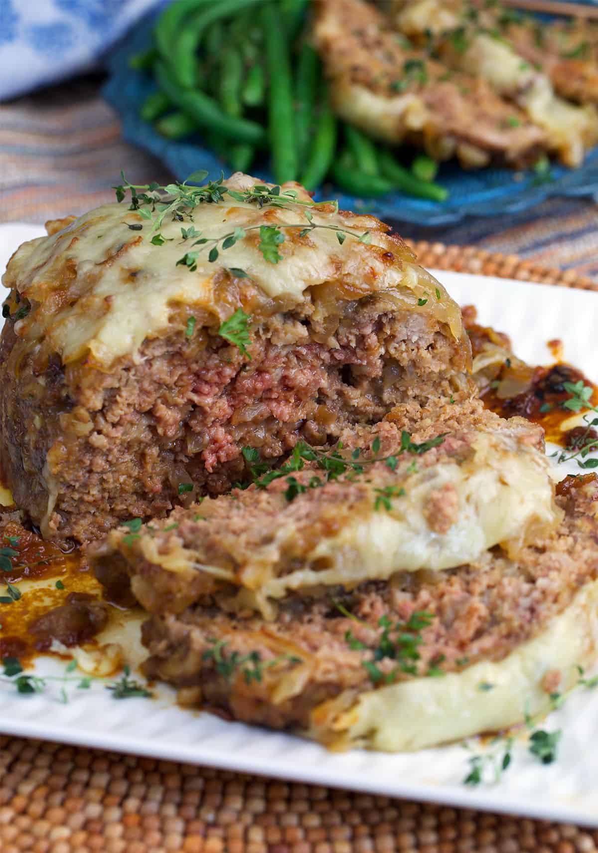 French Onion Meatloaf sliced on a white platter