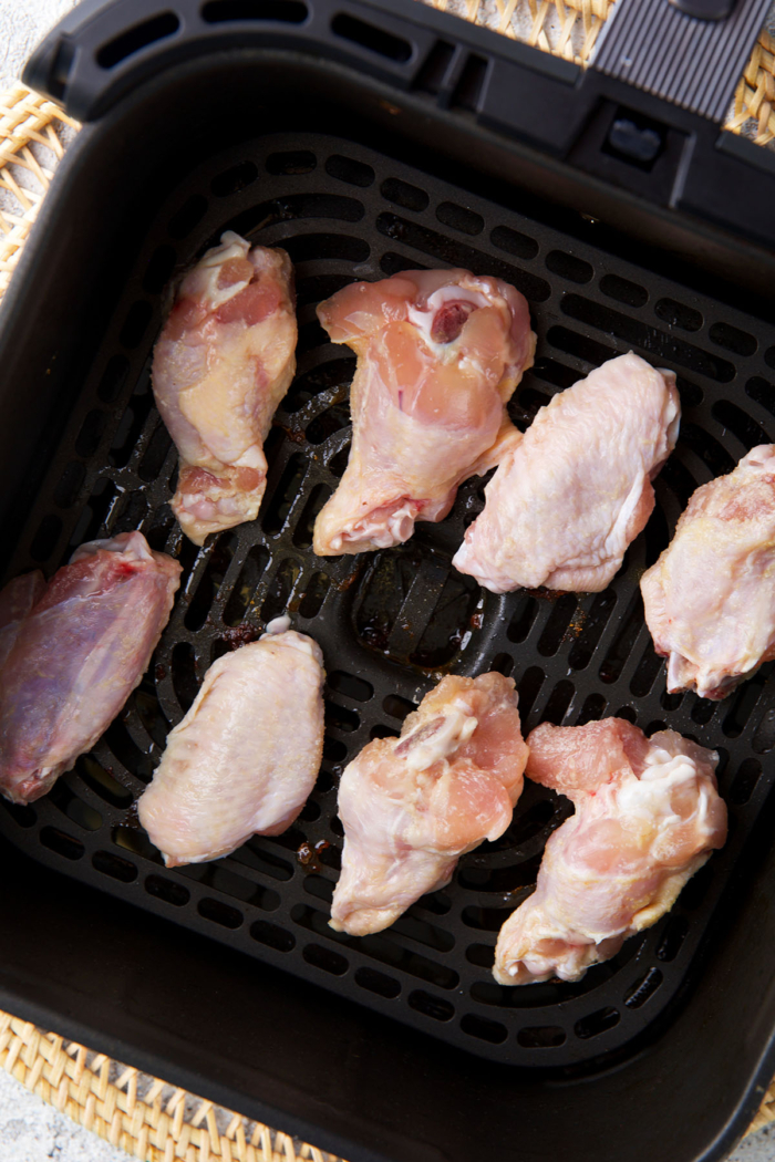 Wings in an air fryer getting ready to be cooked