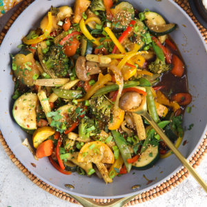 Homemade Vegetable Stir Fry in a wok with a serving spoon.