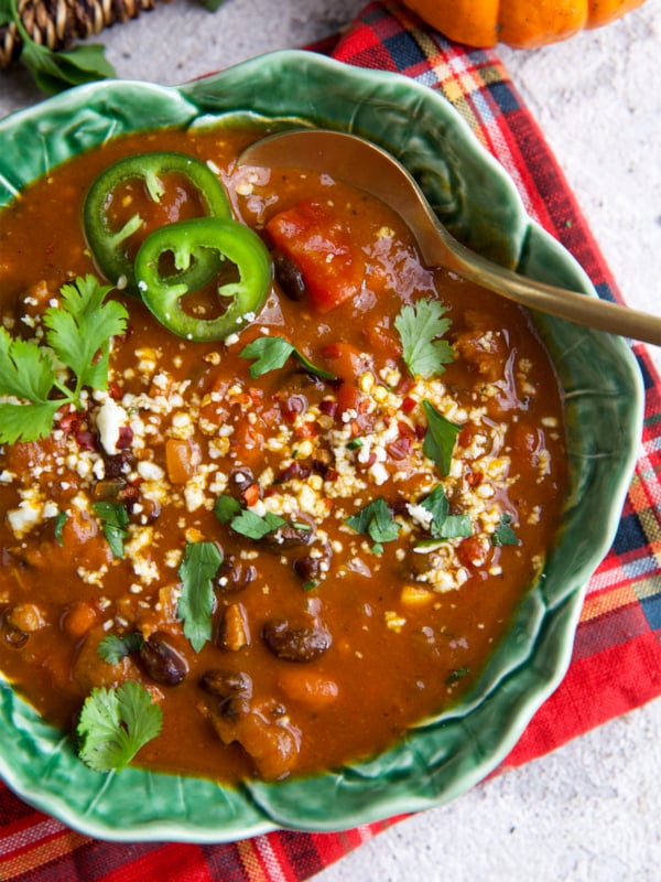Bowl of pumpkin chili with sausage and black beans
