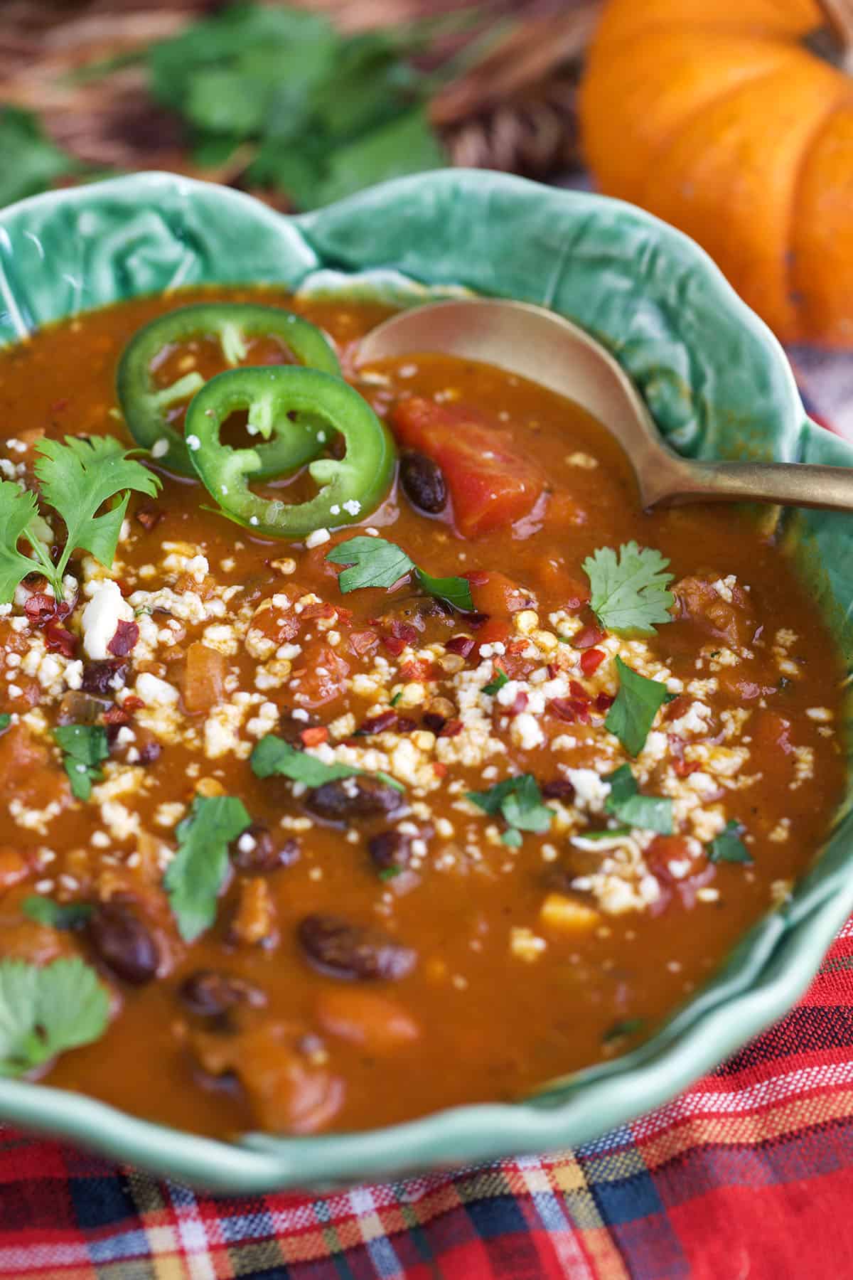 Cozy pumpkin chili topped with cheddar and cilantro,