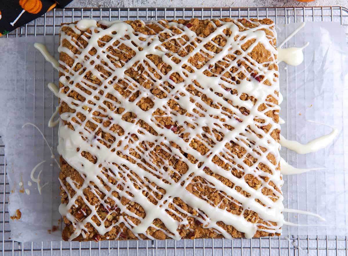 Pumpkin Coffee Cake on a piece of parchment on a cooling rack.