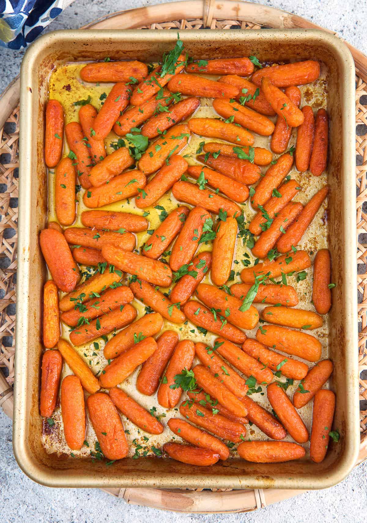 baby carrots on a sheet pan after being roasted in the oven.