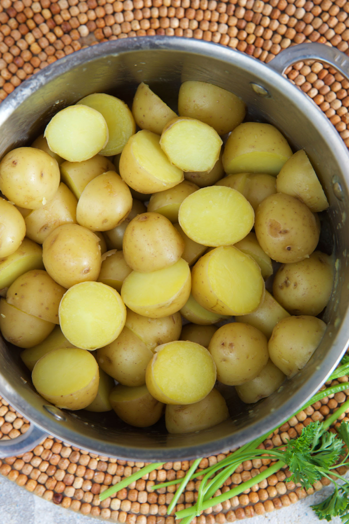 baby Yukon gold potatoes in a pot after being parboiled
