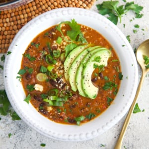 Black Bean Soup in a white bowl with avocado on top
