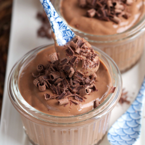Chocolate Protein Pudding with a blue and white spoon.