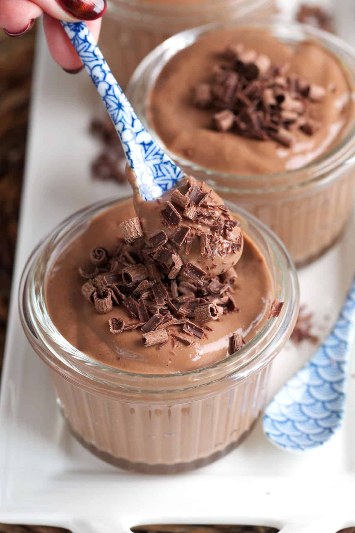 Chocolate Protein Pudding with a blue and white spoon.