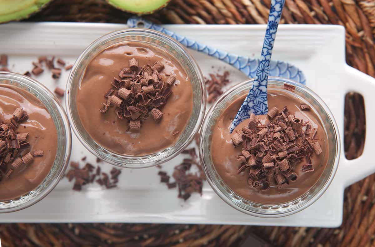 Protein pudding in glass jars on a white serving platter