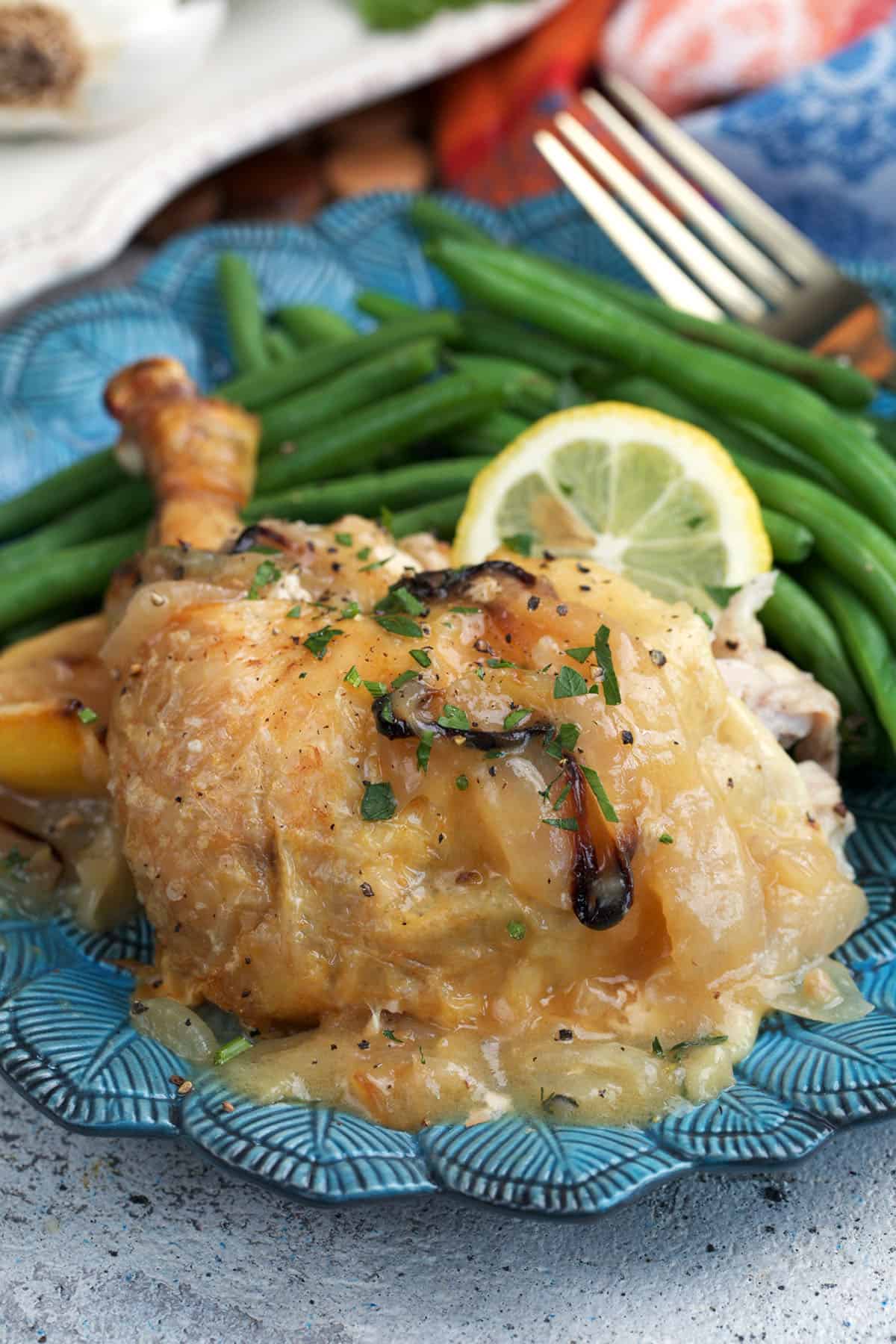 Ina Garten engagement chicken leg on a plate with green beans