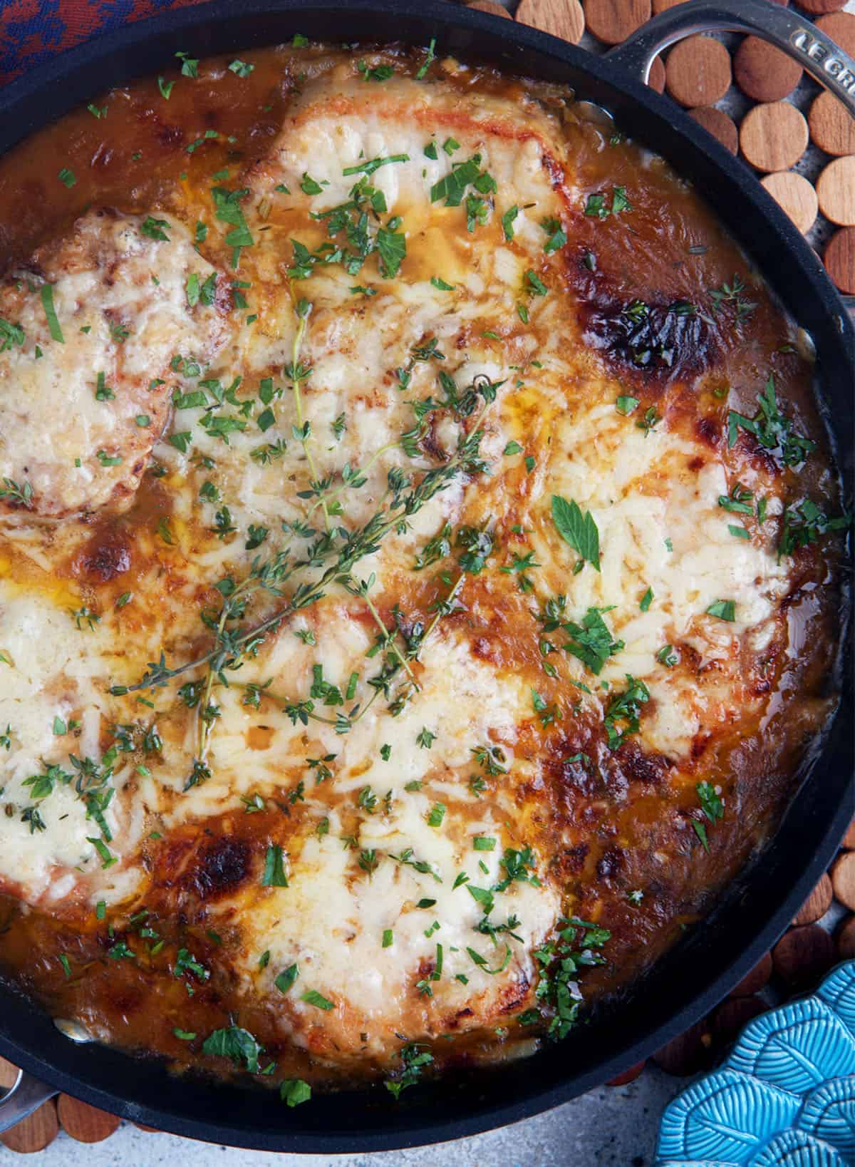 French Onion Pork Chops in a cast iron skillet
