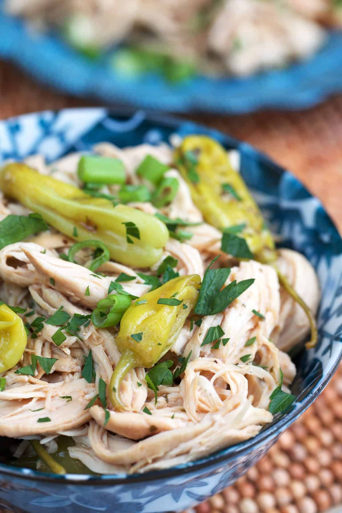 Mississippi chicken in a blue and white serving bowl