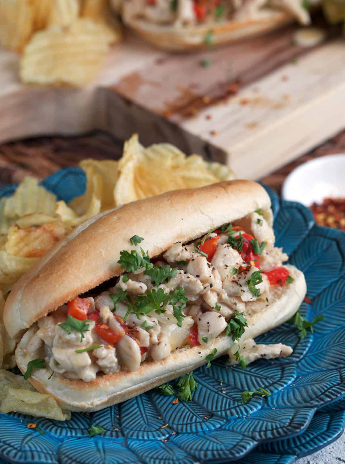 chicken cheesesteak sandwich on a blue plate