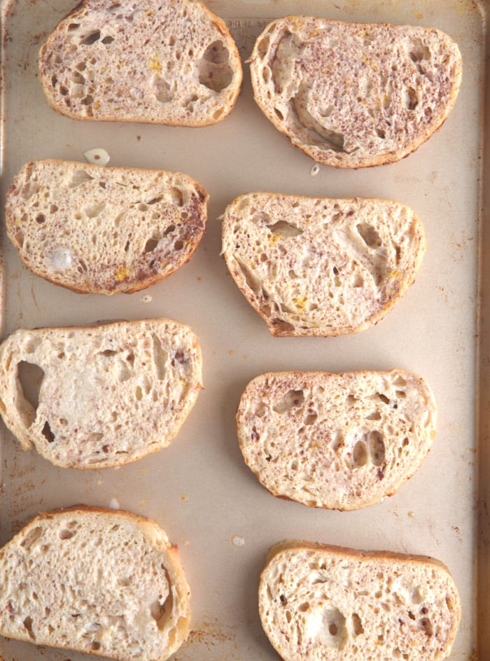 sourdough French toast on a baking sheet after being dipped in egg custard