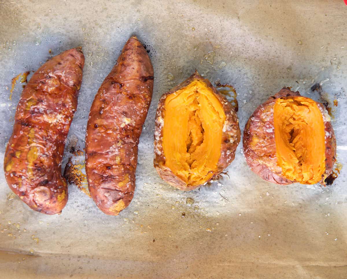 Stuffed Sweet Potatoes on a baking sheet split and ready to be filled.