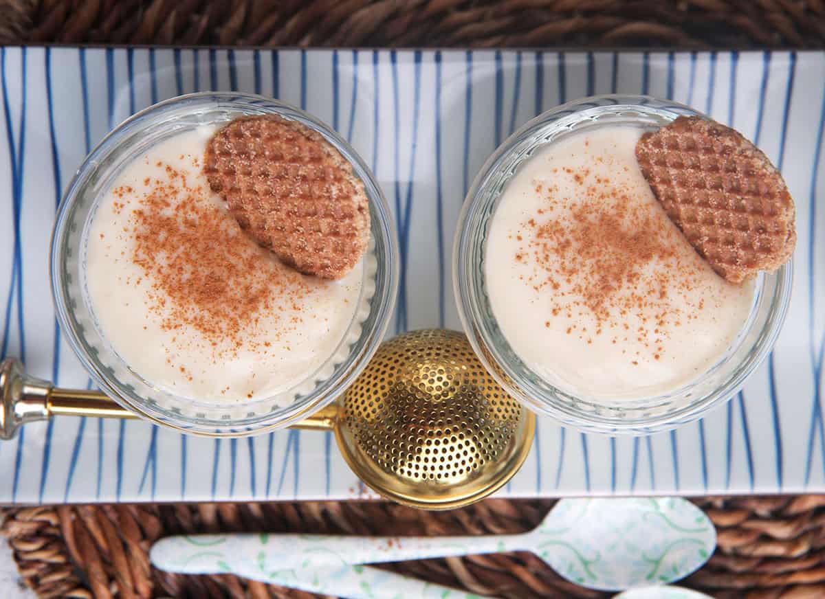 two jars filled with vanilla pudding on a tray.