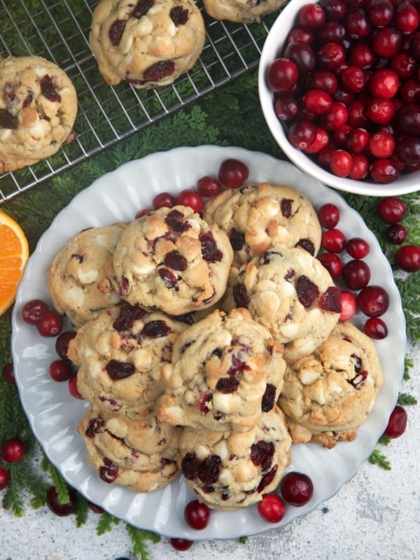 White chocolate cranberry cookies on a serving platter for a Christmas cookie exchange.