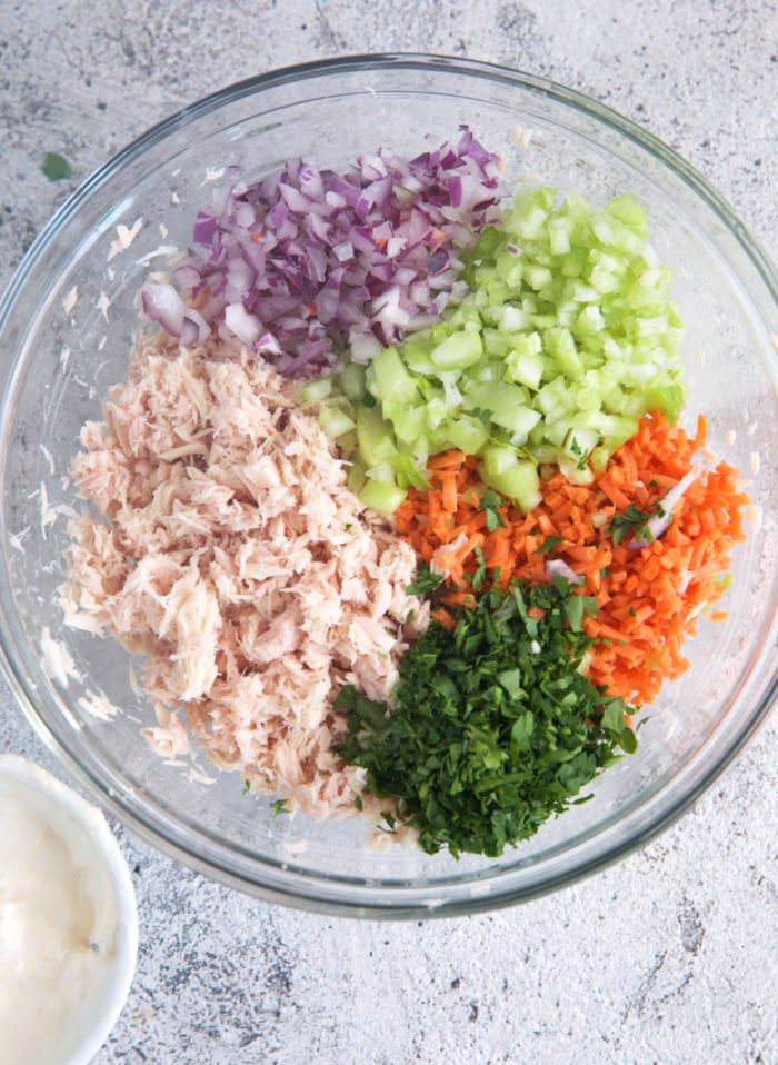Tuna salad ingredients in a glass bowl