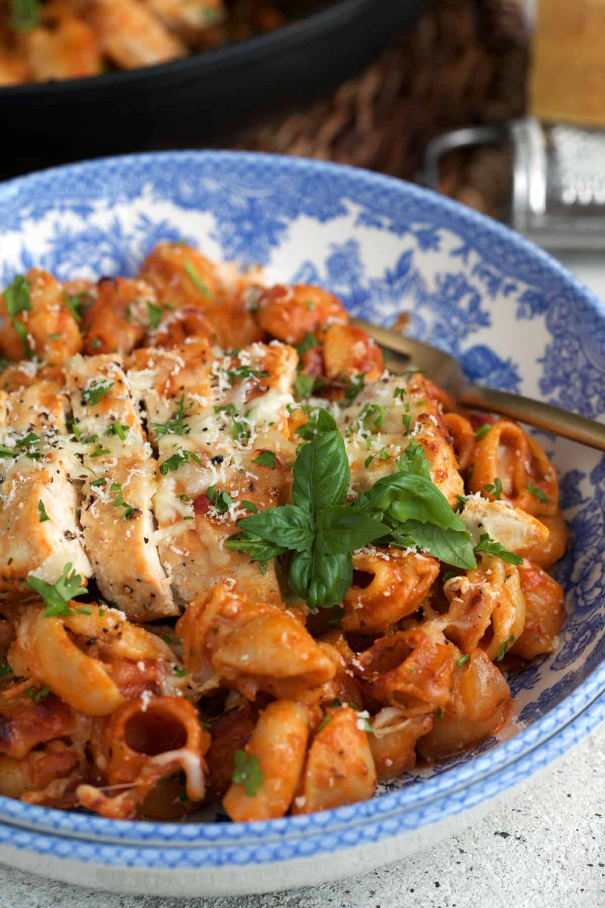 one pan chicken dinner in a white and blue bowl.
