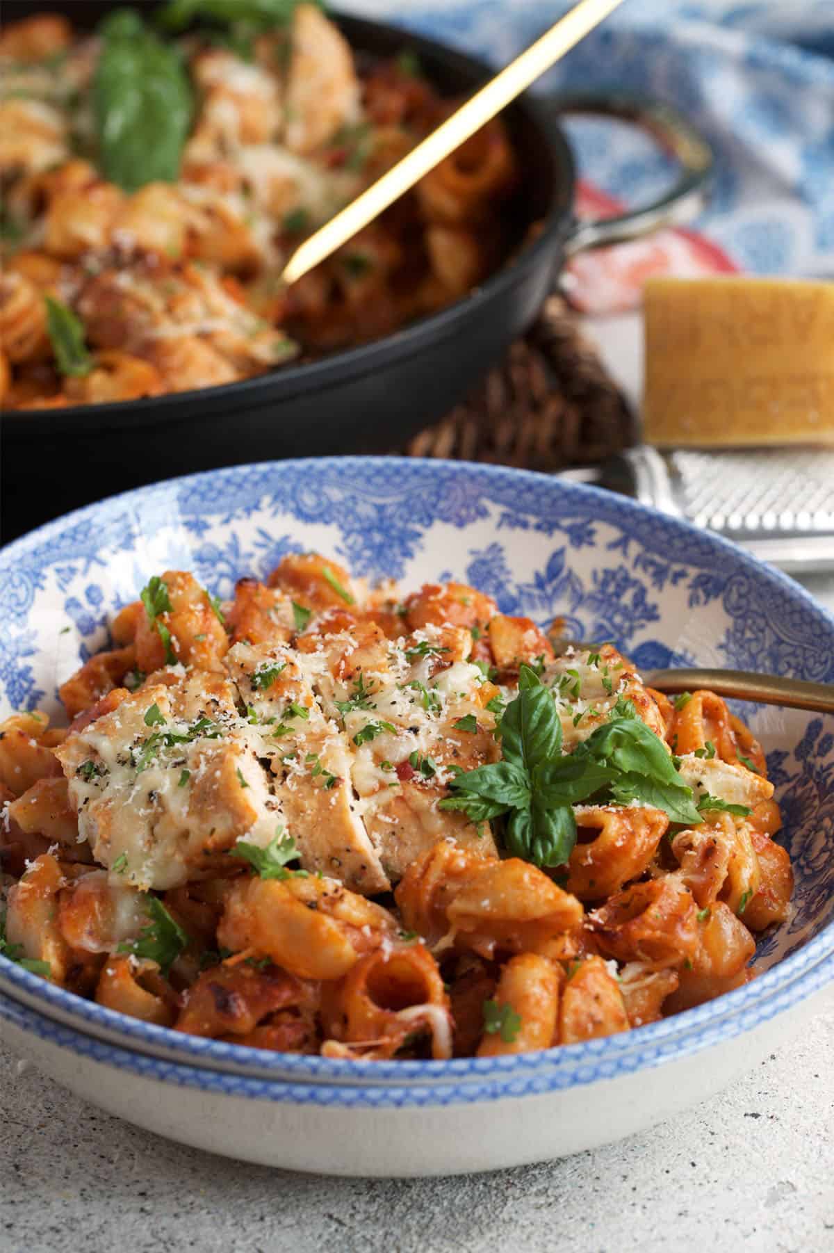 Chicken Parmesan Pasta served in a blue and white transfer ware bowl.