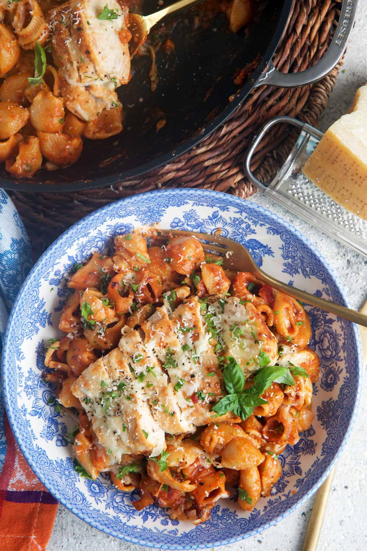 one pot Chicken parm pasta in a skillet with a serving in a bowl