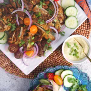 Sheet pan chicken shawarma on a white platter