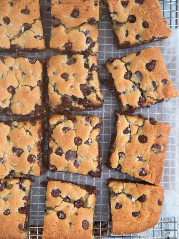 Chocolate chip Cookie Bars cut into squares on a baking cooking wrap