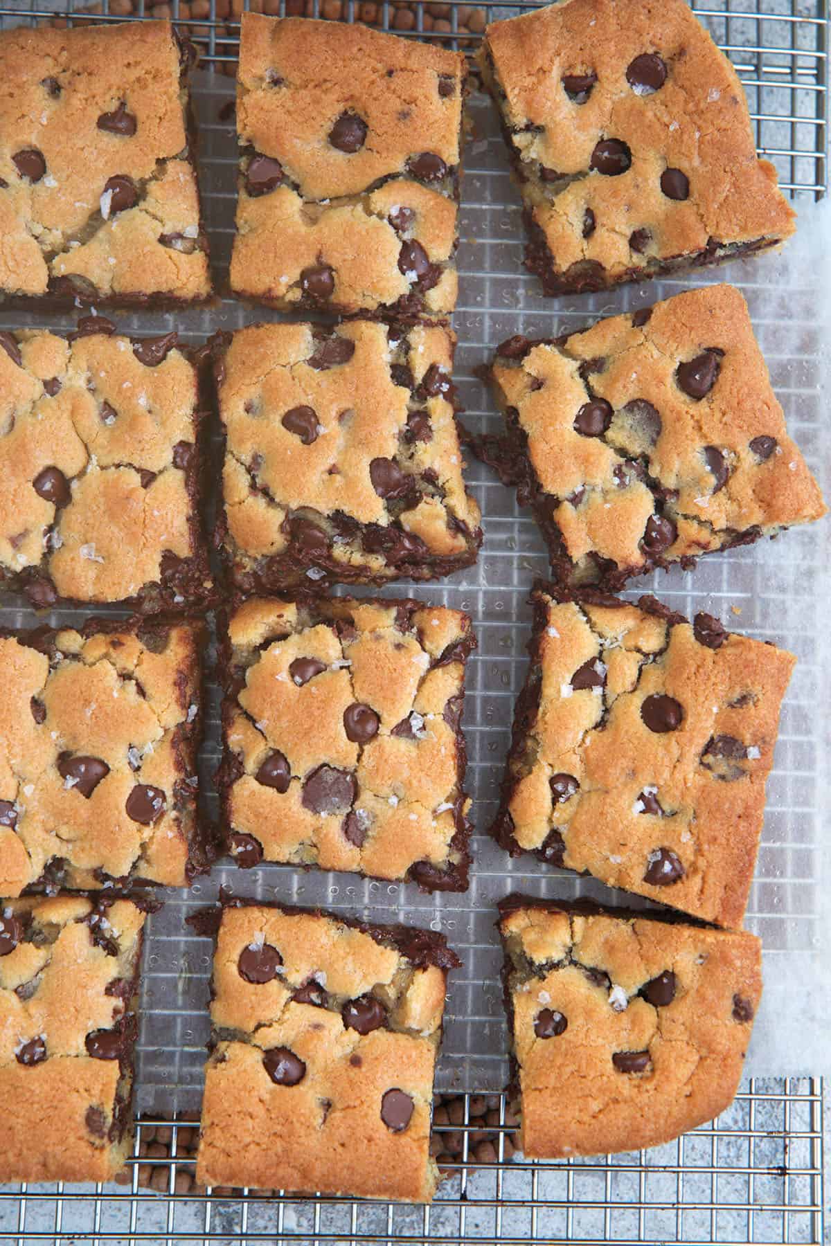 Chocolate chip Cookie Bars cut into squares on a baking cooking wrap