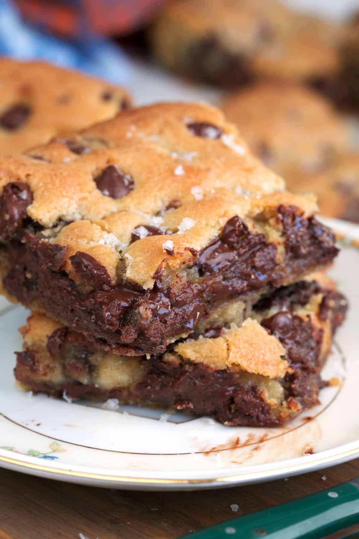 Chocolate chip Cookie bars on a white plate with gooey melted chocolate chips.