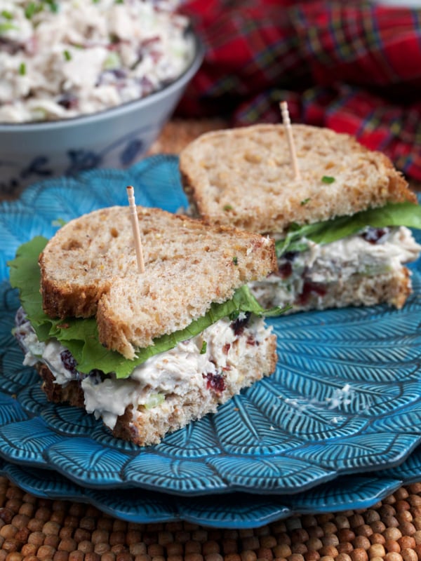Cranberry Chicken Salad Sandwich on wheat bread plated on a blue plate