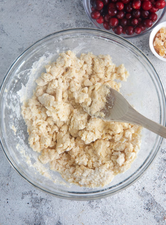 dough for cranberry orange scones in a glass mixing bowl