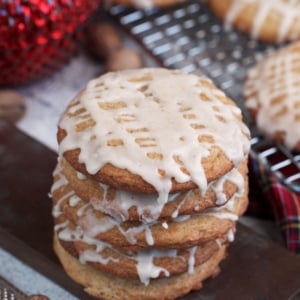 Soft Chai Eggnog Cookies with eggnog glaze on a board.